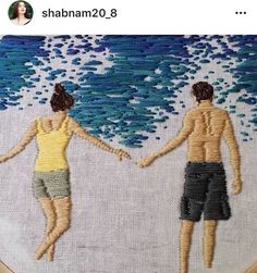 two people holding hands while standing in front of an ocean wave embroideryed on a hoop