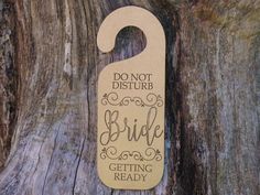 a wooden door hanger that says, don't disturbs the bride getting ready