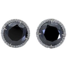 A versatile piece of jewelry that goes well with any outfit. Features two round black diamonds set in a brilliant diamond halo basket made in 18k white gold. Black diamonds weigh 17.88 carats total. 0.65 inches in diameter. Luxury Jewelry With Round Cut Black Diamonds, Formal Round Black Diamond Earrings, Formal Black Diamond Round Earrings, Luxury Round Black Diamond Earrings, Luxury Black Diamond Round Earrings, Formal Black Diamond Jewelry With Round Cut, Luxury Black Jewelry With Halo Setting, Black Round Cut Jewelry With Pave Setting, Formal Diamond White Jewelry With Black Diamonds