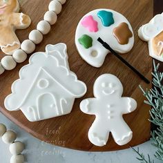 some cookies and decorations on a wooden board