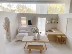 a living room filled with furniture and white walls