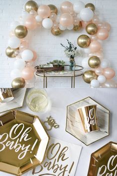 gold and white baby shower decorations with balloons