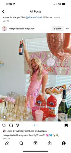 a woman standing in front of a table filled with drinks and confetti bottles