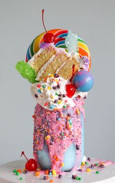 an ice cream sundae with sprinkles, cherries, and candy