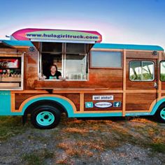 a food truck parked on the side of a dirt road