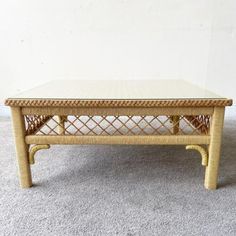 a wicker coffee table on carpeted floor with white wall in the back ground