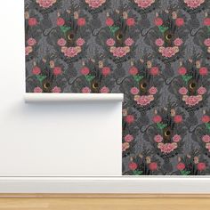 a wallpaper with flowers and cats on it in an empty room next to a white door