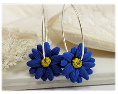 Lightweight style handcrafted Blue Aster hoop earrings on a choice of 20 gauge 925 sterling silver or 14k gold filled 1 inch hoops. -Original hand sculpted polymer clay flowers -Durable, water-resistant -No molds, no paint -Hoop size : 1 inch -20 gauge hoops - choose 925 sterling silver or 14k gold filled View matching collection at: https://www.etsy.com/shop/strandedtreasures/search?search_query=aster Flowers are hand sculpted without molds or paint using polymer clay, a durable water-resistant Blue Flower-shaped Hoop Earrings, Everyday Flower Hoop Earrings, Blue Flower Shaped Hoop Earrings, Everyday Flower Shaped Hoop Earrings, Blue Flower Hoop Earrings As Gift, Blue Flower Hoop Earrings Gift, Blue Everyday Flower Jewelry, September Birth Flower, Aster Flower