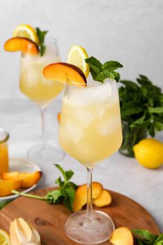 two glasses filled with lemonade and garnished with mint on a cutting board