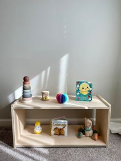 a wooden shelf with toys on top of it