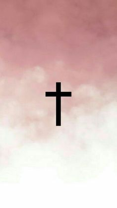 a cross is silhouetted against a pink sky with clouds in the foreground and an airplane flying overhead