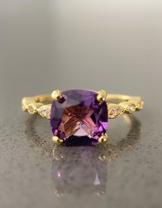 The cushion amethyst is made with 925 sterling silver with 14K gold plating. Cubic zirconia detailing on the band further elevates the appeal of this dainty ring. Amethyst is renowned for its magnificent purple hue. Known for its healing properties, amethyst will bring you in alignment with your thoughts, feelings, and actions.