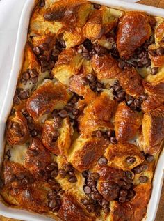 a casserole dish with chocolate beans and puffy pastry toppings on top