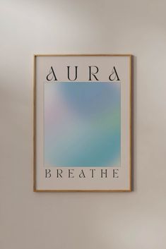 a framed poster with the words aura breathe above it on a wall in an empty room