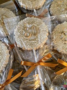 some cookies are wrapped in plastic and sitting on top of each other with ribbons around them