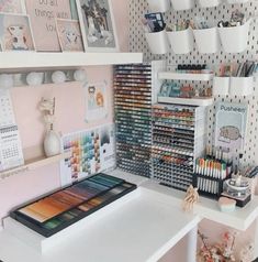 a white desk topped with lots of craft supplies