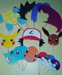 pokemon cupcake toppers are arranged on sticks