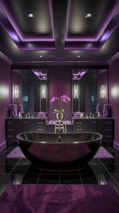 Step into this luxurious bathroom featuring a stunning black tub and rich purple hues. The sleek design is enhanced by ambient lighting and elegant decor, creating a perfect space for relaxation. Discover tips on how to incorporate bold colors and modern fixtures into your own bathroom retreat! #bathroomdesign #purplebathroom Plush Accessories, Orchid Centerpiece, Purple Bathroom, Black Fixtures, Luxury Bathroom Design, Black Tub, Plush Rugs, Modern Luxury Bathroom, Purple Bathrooms