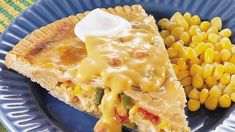 a blue plate topped with a piece of pie and corn