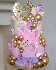 a multi layer cake decorated with gold and pink butterflies