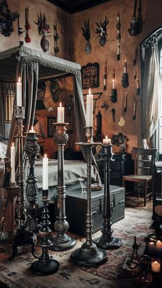 an old fashioned bedroom with many candles on the bed and antlers hanging from the wall