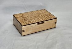 a wooden box sitting on top of a white surface