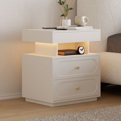 a night stand with two drawers and a clock on it