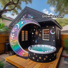 an inflatable hot tub with stars and moon designs on the side, next to a wooden deck