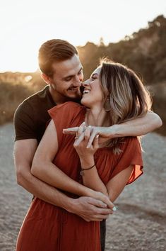 a man and woman are hugging each other