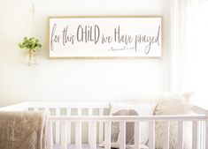 a baby's crib with a sign above it