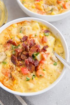 two white bowls filled with food on top of a table