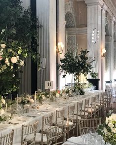 the tables are set with white linens and floral centerpieces for an elegant wedding reception