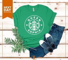 a green t - shirt with the starbucks logo on it next to jeans and shoes