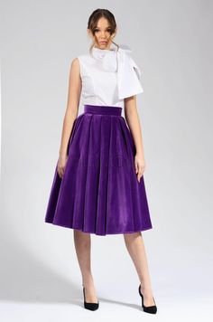 This purple velvet circle skirt is a must-have for any woman's wardrobe. It's made from 100% cotton, so it's both soft and elegant. The skirt has a high waist and a full circle skirt, which gives it a flattering and feminine look. The skirt is also lined, so it's comfortable to wear. This skirt is perfect for any occasion, from a night out to a special event. It can be dressed up or down, depending on the occasion. The purple color is versatile and can be paired with a variety of tops and access Cotton Long Skirt For Party, Flared Cotton Skirt For Party, Chic Velvet Party Skirt, Party Full Skirt In Cotton, Cotton Full Skirt For Party, Party Pleated Cotton Skirt, Purple Pleated Skirt For Party, Elegant Velvet Party Skirt, Elegant Purple Knee-length Skirt