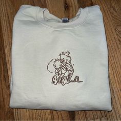 *Please Allow Up To A Week For Your Order To Be Shipped Due To Increased Demand And Because These Items Are Handmade* This Is A Made-To-Order “Calvin And Hobbes” Design Embroidered On A Tan Gildan Heavy Blend Crewneck Sweatshirt. The Photos Are Of One I Made Myself So It Will Look Exactly Like That! Available In Sizes S-Xxl! The Sizing Is Unisex And Fits True To Size. I Also Do Custom Embroidery Orders Feel Free To Message Me Here For More Information! Thank You For Checking Out My Listing, And Vintage Apparel, Embroidered Clothes Men, Mens Embroidery, Purple Sweatshirt, Diy Sweatshirt, Blue Crewneck, Black Crewneck, Gildan Sweatshirts, Calvin And Hobbes