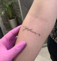 a person with a tattoo on their arm that reads, jellolac in cursive writing