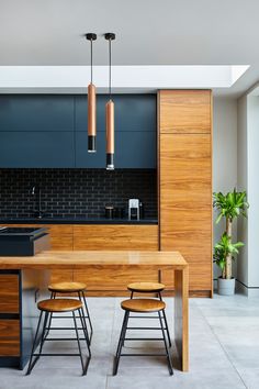 a modern kitchen with black and wood accents