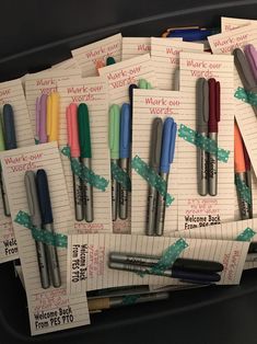 several pens are lined up on top of each other in front of notepads