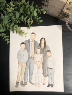 a watercolor drawing of a family on paper next to a box with leaves in it