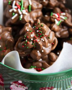 a bowl filled with chocolate covered pretzels and sprinkles on top