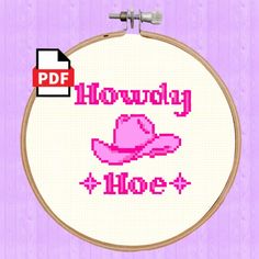 a cross stitch pattern with the words hollywood and a pink cowboy hat on it's side