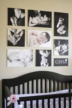 a baby's room with black and white pictures on the wall, pink flowers in vases