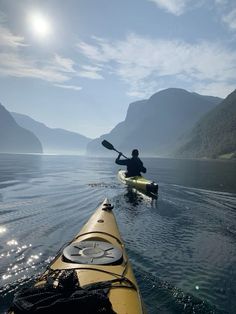 a person in a kayak paddling on the water