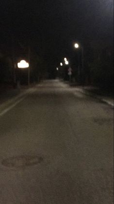 an empty street at night with no cars on it