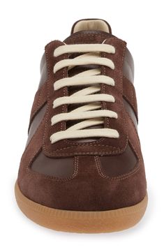 Based on a '70s Austrian sport shoe, this low-top sneaker features signature numerical debossing at the tongue and a single white basting stitch at the back. Lace-up style Removable insole Leather or textile upper/leather and textile lining/synthetic sole Made in Italy Men's Designer Shoes Basting Stitch, Maison Margiela Replica, Margiela Replica, Sport Shoe, Chic Sneakers, Mens Designer Shoes, Up Styles, Low Top, Designer Shoes