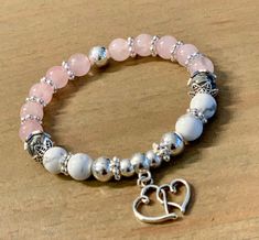 The Love Hearts Stretch Stacking Bracelet is crafted with 8mm Genuine Rose Quartz, 8mm Natural Howlite Stones, 8mm Natural Gray Jasper Stones, 6 & 8mm silver plated beads & silver plated Bali-style spacer beads adorned with silver plated hearts charm on strong stretch cord. Each bracelet is custom hand crafted by me... I use high quality stones, beads & findings to create unique one of a kind pieces you'll enjoy gifting & wearing for years. Please select a size on the drop down menu. If you need a different size please send me a message at check out. ✭ Due to the nature of handmade, natural gemstones and computer screens your jewelry is subject to slight color variations. Bali Style, Howlite Stone, Bali Fashion, Love Hearts, Jasper Stone, Quartz Rose, Bracelet Stack, Stretch Bracelet, Spacer Beads