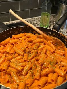 a pan filled with pasta on top of a stove