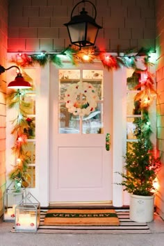 the front door is decorated with christmas lights and garlands, including pine cones on either side