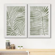 two green leaves are hanging on the wall next to a heater in a living room