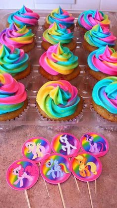 cupcakes with rainbow frosting and little pony on them